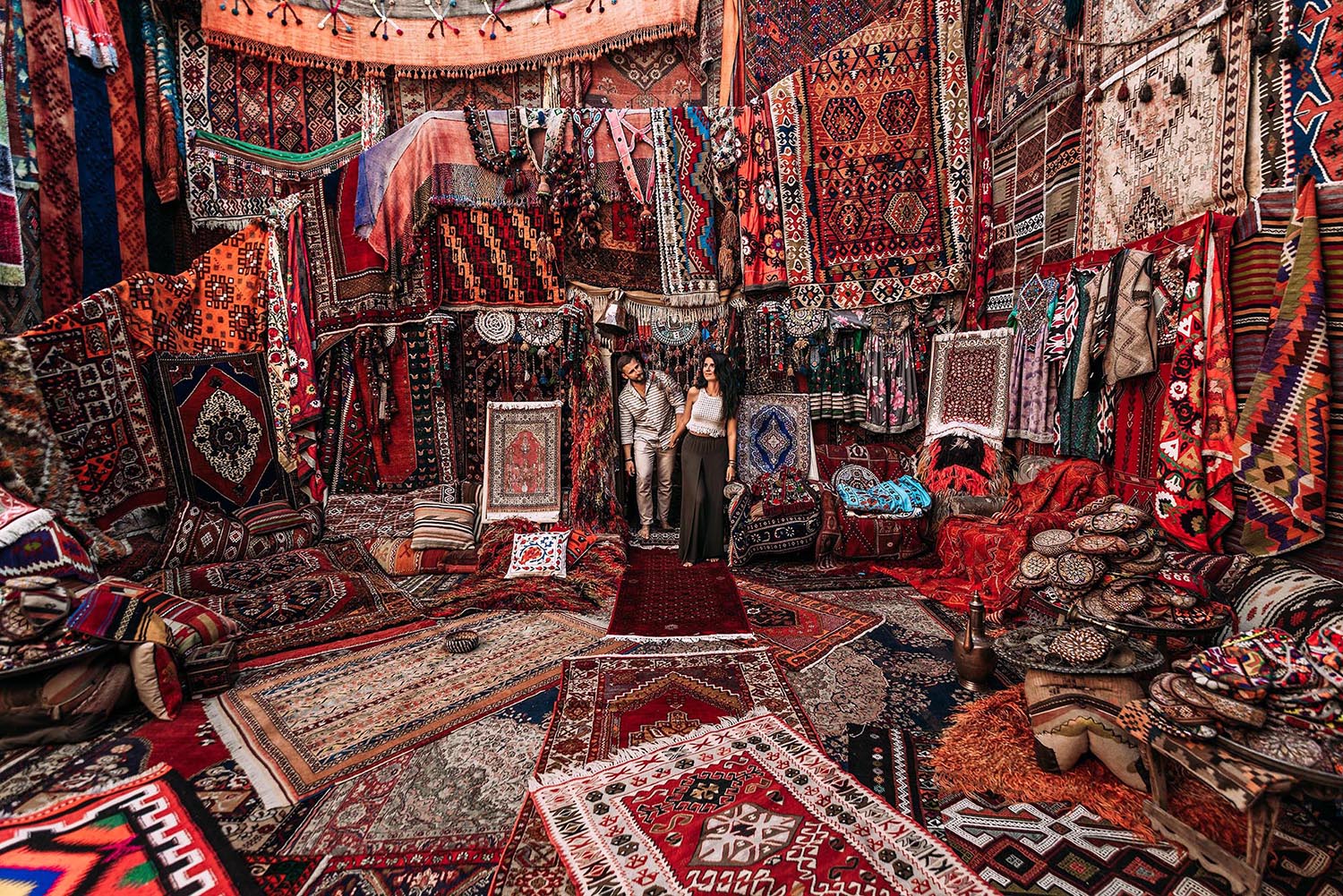 Man and woman in the store. Couple in love in Turkey. Man and woman in the Eastern country. Gift shop. A couple in love travels. Persian shop. Tourists in store. Oriental carpet. Istanbul. Cappadocia